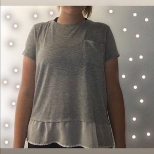 light grey shirt with white ruffle at bottom